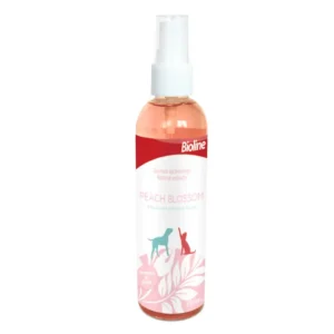 Bioline Peach Blossom Deodorant Freshening Spray 118ml bottle, showing a mist being applied to a pet's coat for odor control.