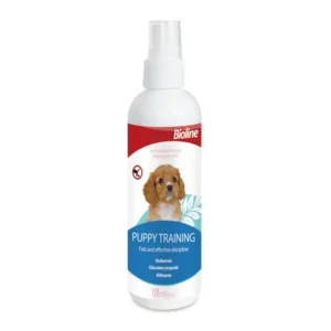 Bioline Puppy Training Spray 120ml bottle, showing a puppy being guided to a training pad, emphasizing its use as a housebreaking attractant.